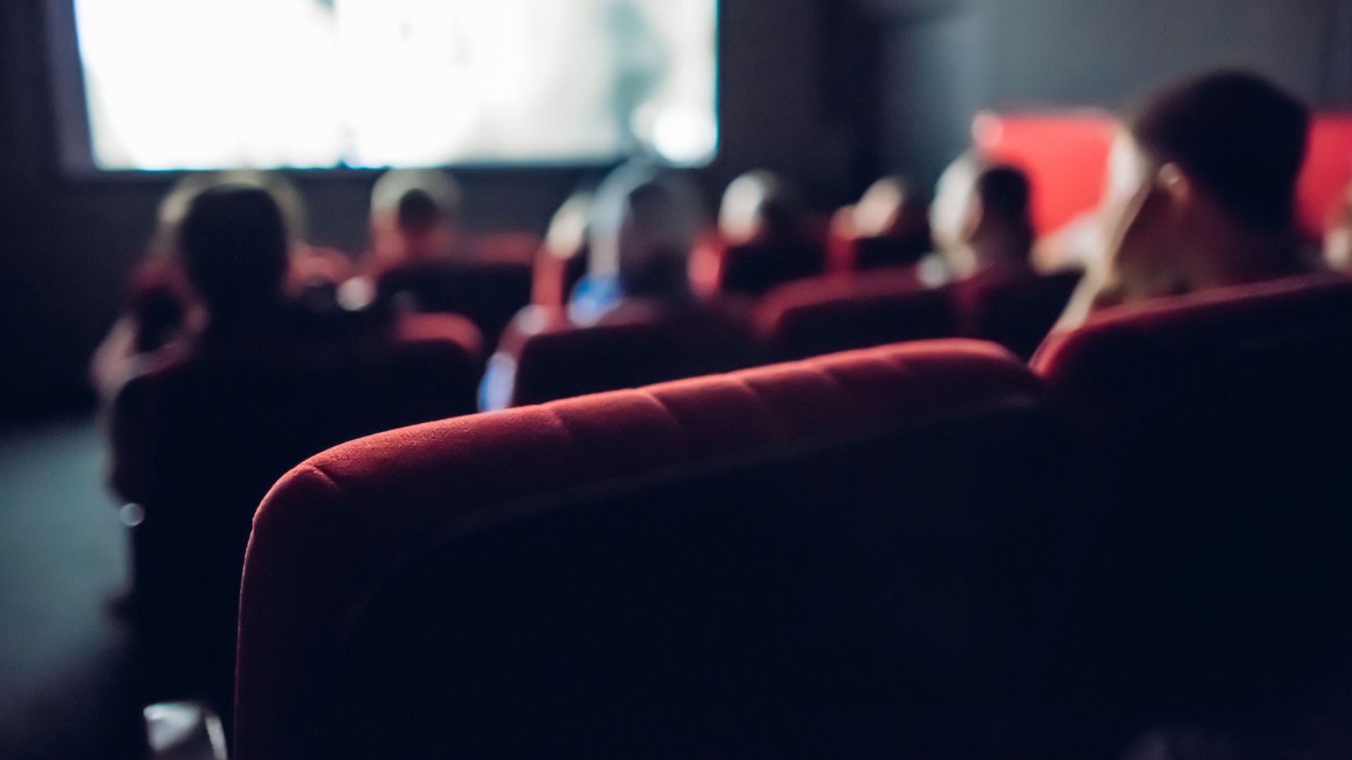 an empty seat in a semi-crowded movie theater