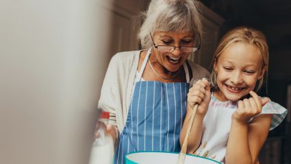 elderly woman and little girl baking together