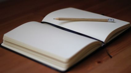 open notebook with a pencil