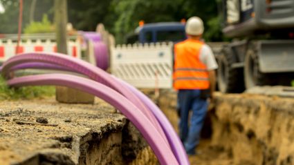 A worker installing broadband cable.