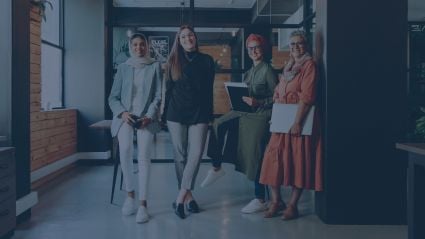 four women in a professional setting