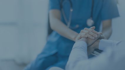 a healthcare professional holding a patient's hand