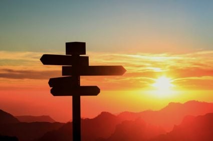 A roadsign against a sunset backdrop