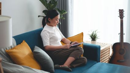 Woman sitting on a couch looking at her phone