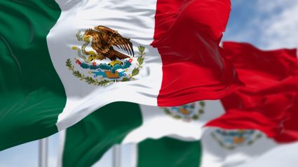 Three Mexican flags blowing in the wind