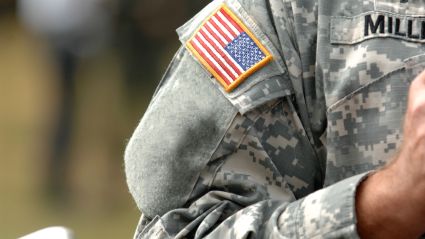 Close up of the American flag on the arm of a US military member.