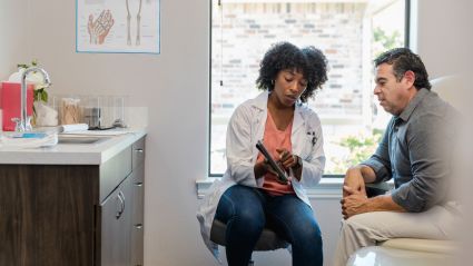 a man and woman sitting in a doctor's office