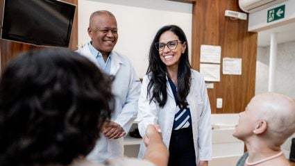 A doctor shakes the hand of a patient.