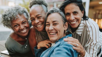 Four women smiling.