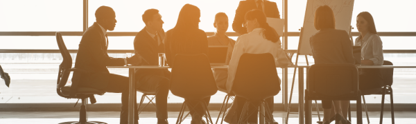 People in business attire sit around a table