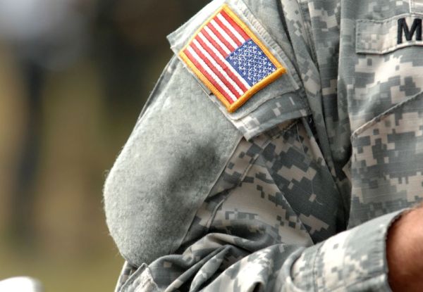 US soldier with American flag on their sleeve.