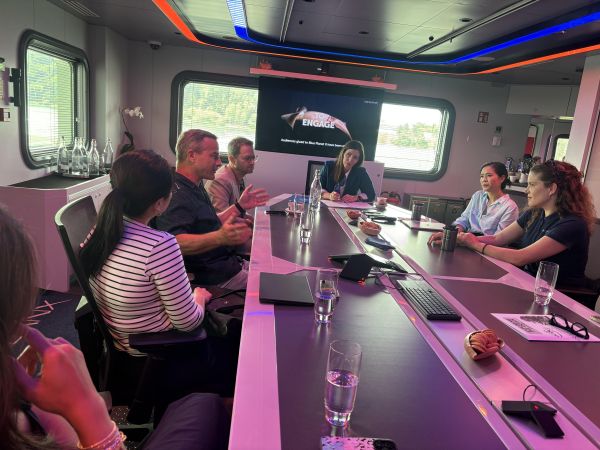 Emily Musil, center, together with experts, philanthropists, and entrepreneurs aboard the OceanXplorer.