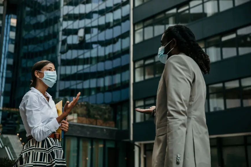 two women wearing masks