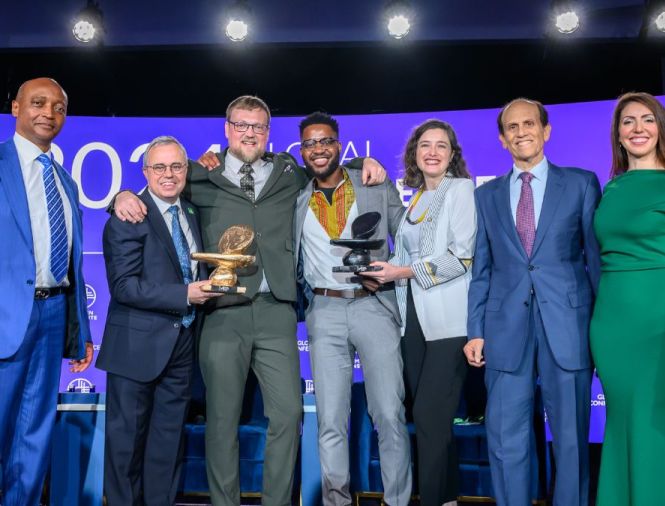 The Milken-Motsepe Innovation Prize Program team posing with Mike Milken on stage after panel at Global Conference 2024