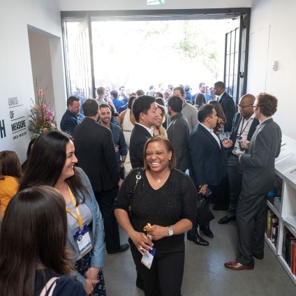 A group of people talking and mingling at an event