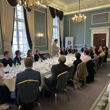 A group of people sit around a table for a discussion