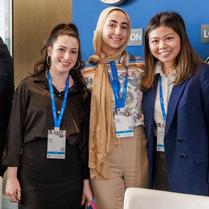 A group of three women pose for a photo