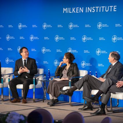 A group of panelists sit on stage for a discussion