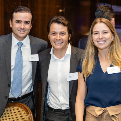 three people at the Milken Institute Brazil Global Dinner Dialogues posing together