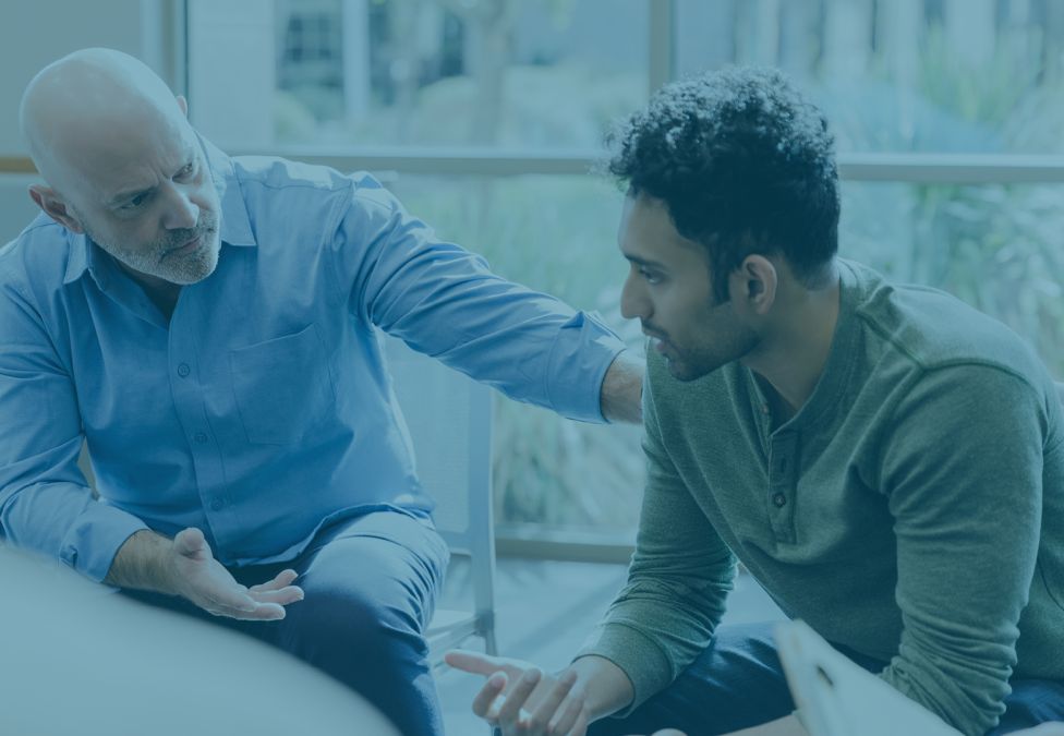 older man talking to younger man