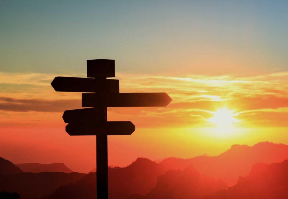 A roadsign against a sunset backdrop