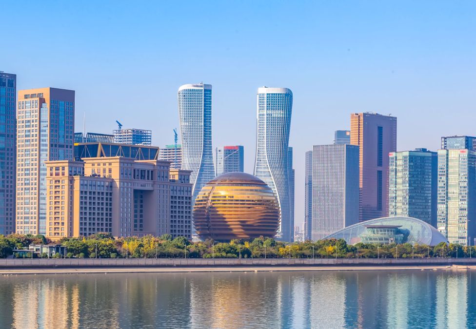 A skyline of a city shot from across a river.