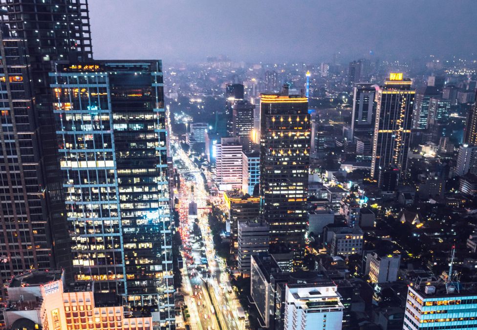 An aerial shot of a downtown of a city at night