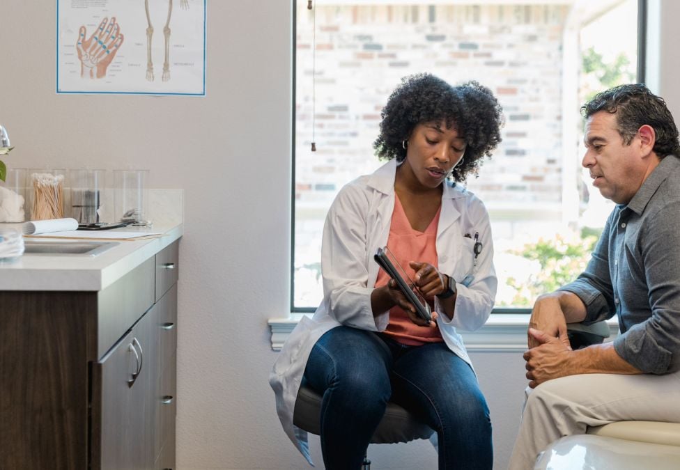 a man and woman sitting in a doctor's office