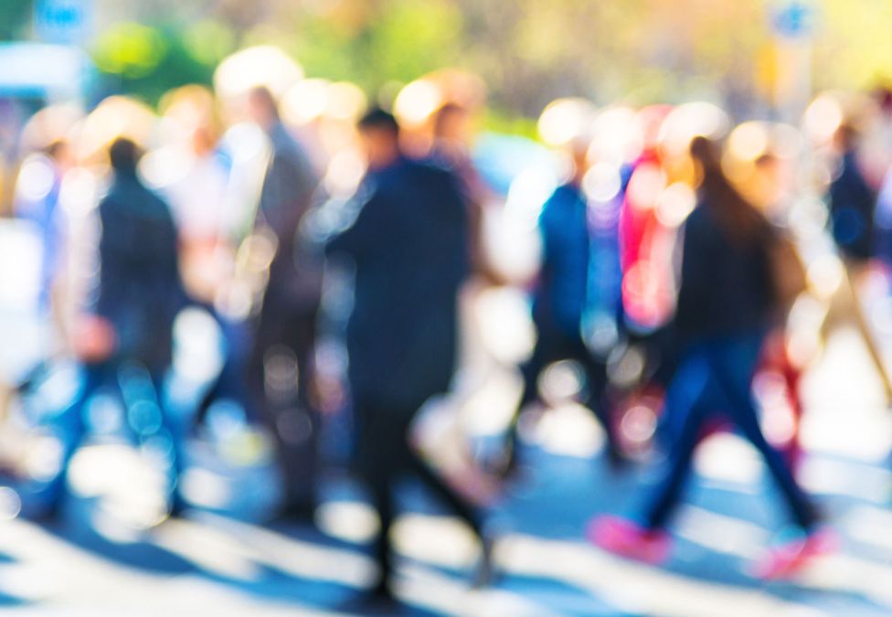 A blurry photo of a crowd of people, to represent failing vision.