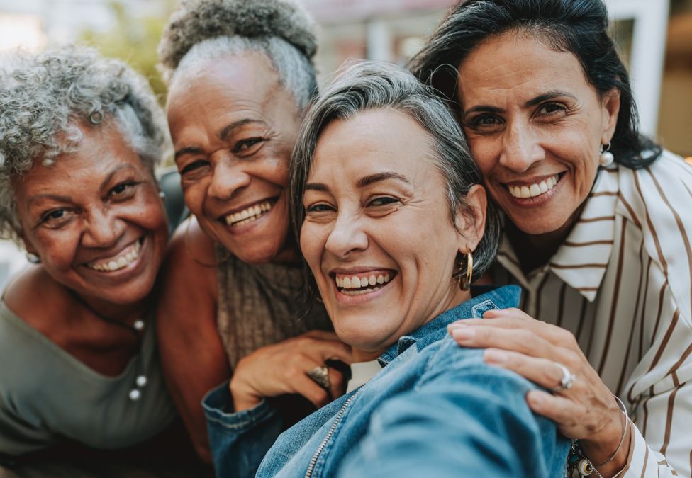 Four women smiling.