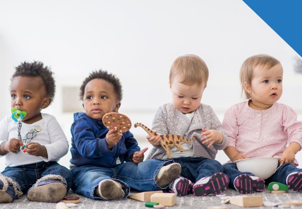 An image of four diverse babies leading to an article titled "The Economic Impact of Invest America Accounts".