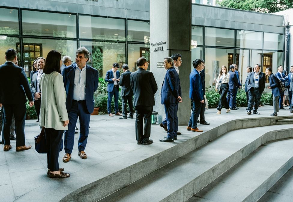 People standing outside of building dressed in business clothing 